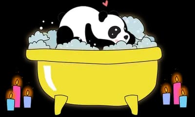 Panda bathing in a yellow tub of bubbles
