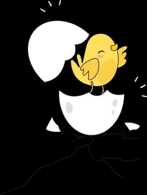 Chick sitting in a cracked eggshell