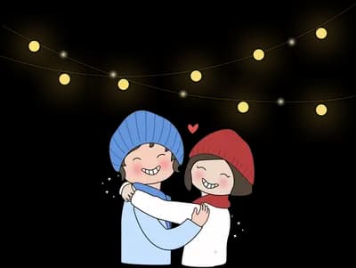 Couple embracing under a string of fairy lights