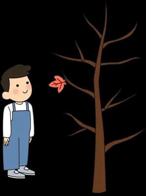 Boy standing beside a bare tree with falling leaves