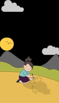 Boy digging in sandy ground on a hillside with the sun over the mountains