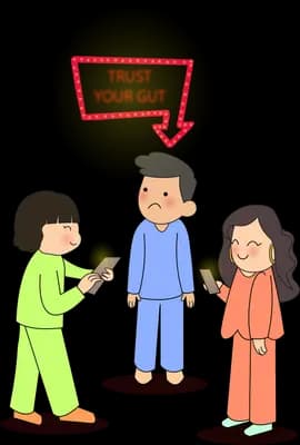 Three people talking while a sign with an arrow points down at the man between them