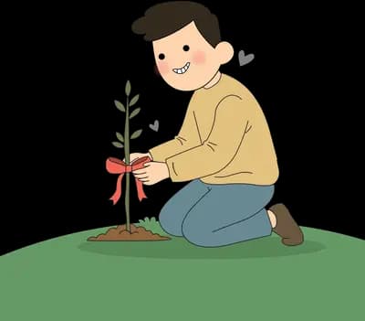 Man kneeling on grass to tie a red ribbon around a young sapling