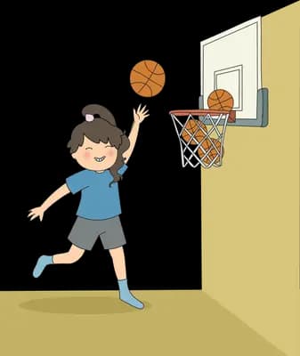 Boy leaping to dunk a basketball into a wall-mounted hoop