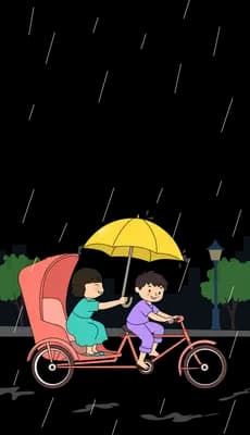 Two children riding a cargo trike under a yellow umbrella on a street