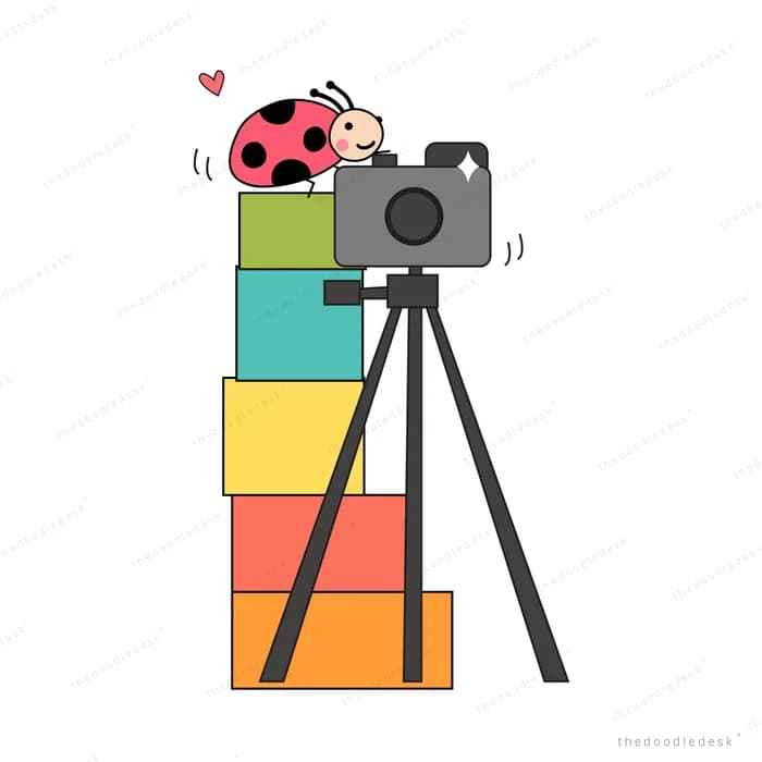 Camera on a tripod stacked over colourful blocks