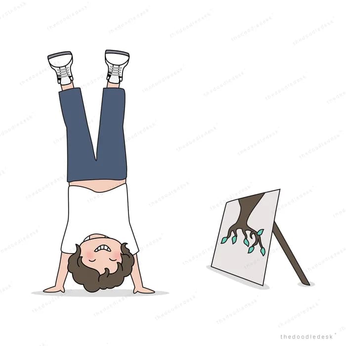 Person doing a headstand beside a small easel