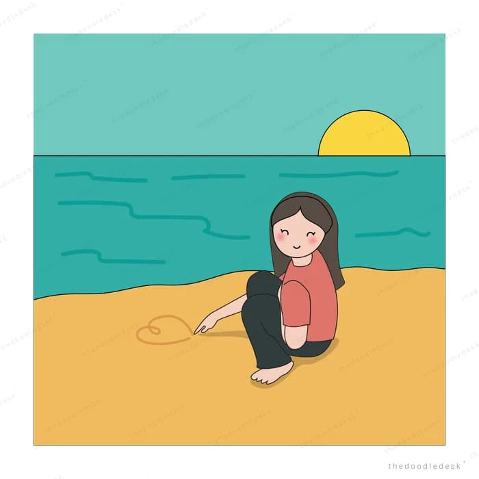Woman sitting on a beach watching the sunset