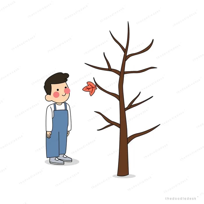 Boy standing beside a bare tree with falling leaves