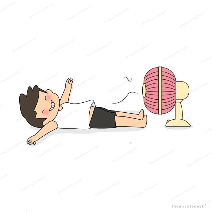 Boy lying on the floor in front of an electric fan