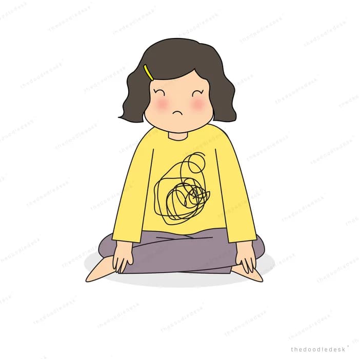 Woman sitting cross-legged looking downcast