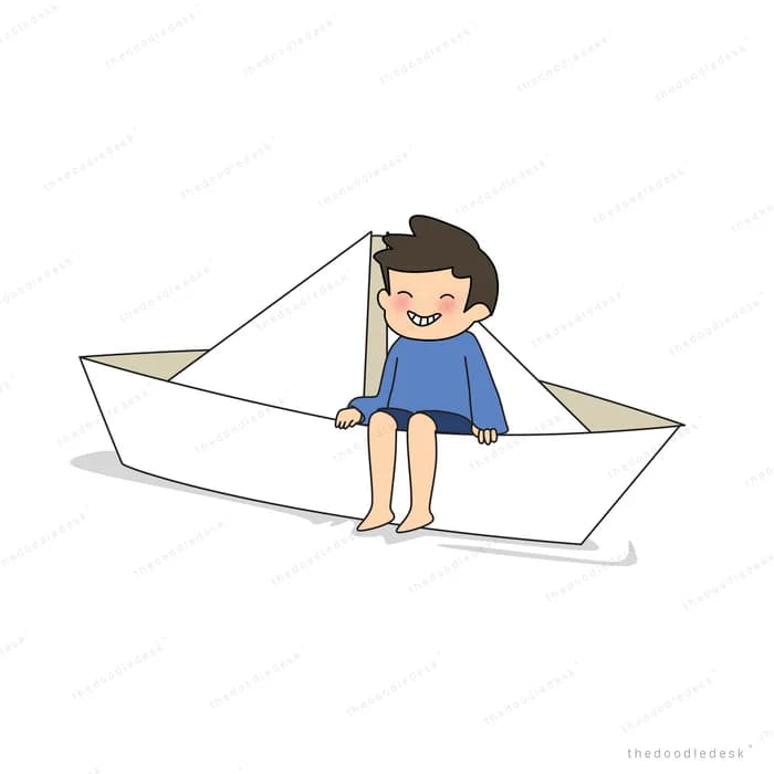 Boy sitting inside a large folded paper boat