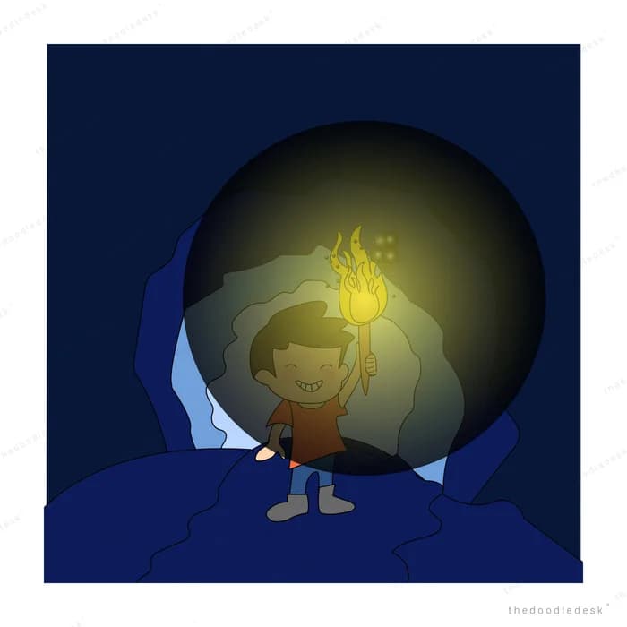 Boy holding a burning torch inside a dark cave mouth at night
