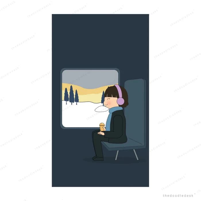 Girl in headphones sitting on a train looking out at a snowy landscape