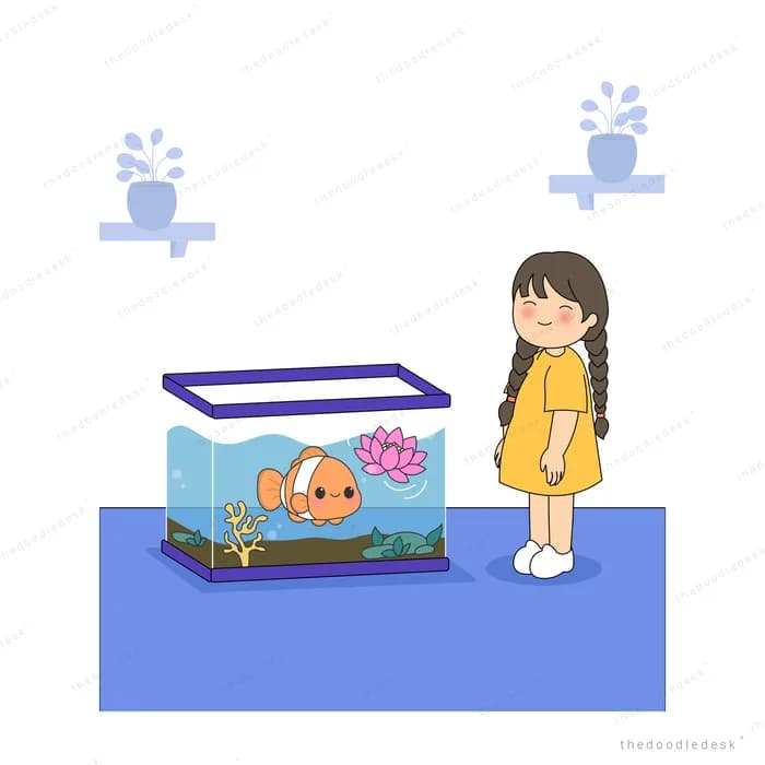 Girl in yellow standing beside a fish tank holding a clownfish