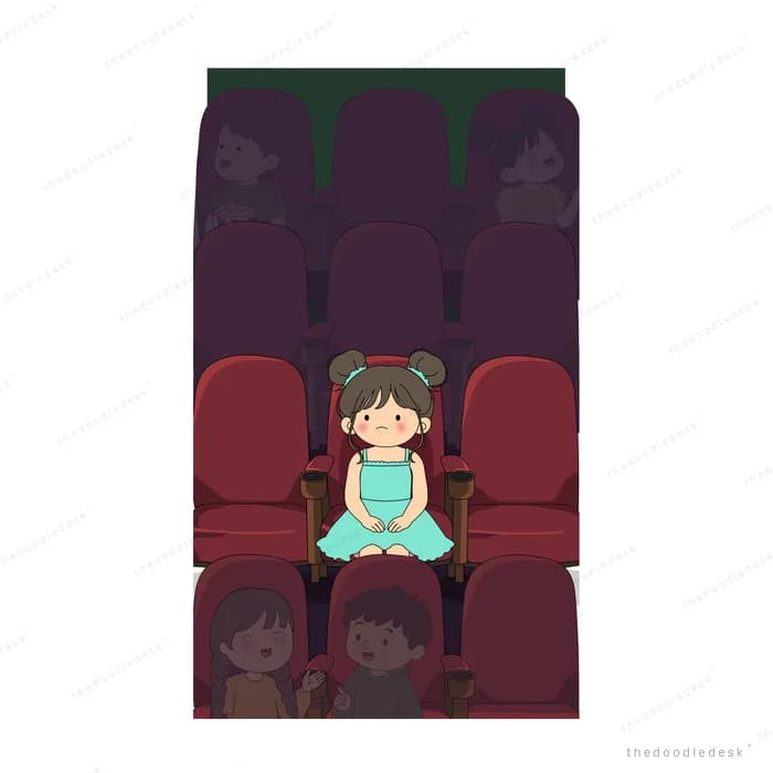 Two children seated in a dim cinema row eating popcorn