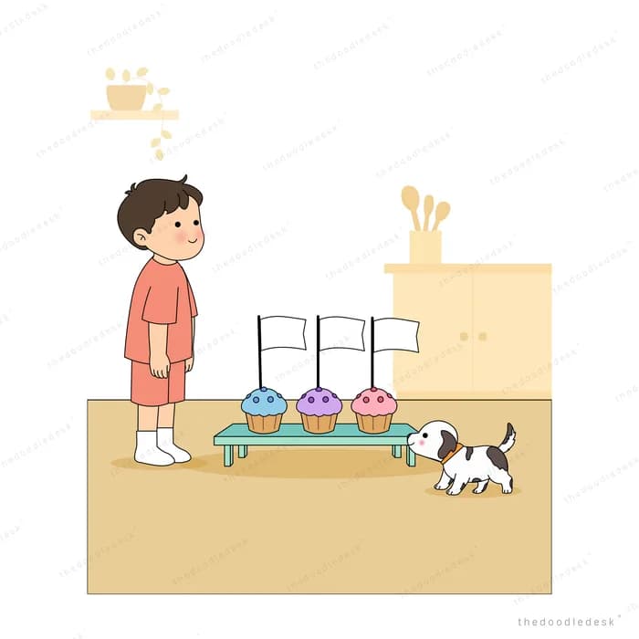 Boy in a mask standing by a bench of three cupcakes while a puppy sniffs around