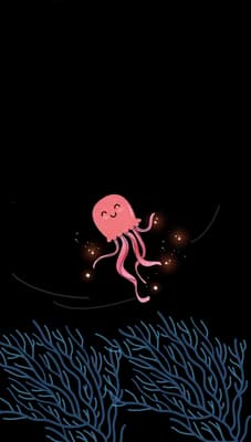 Jellyfish drifting above pale coral