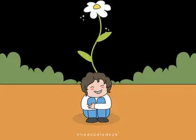 Boy sitting beneath a tall flower on brown ground