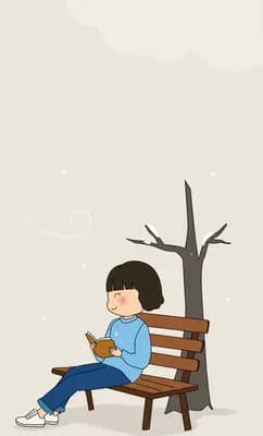 Girl sitting on a bench beneath a bare winter tree
