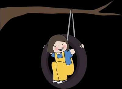 Child sitting in a tyre swing hanging from a branch