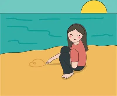 Woman sitting on a beach watching the sunset