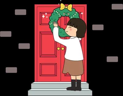 Girl hanging a wreath on a red front door