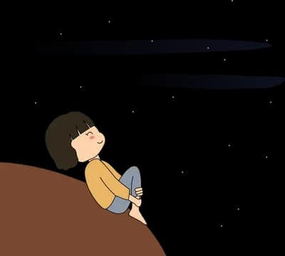 Girl sitting hugging her knees on a brown hillside watching clouds drift
