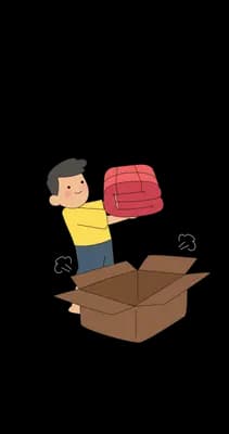 Man packing a red bundle into a large open cardboard box