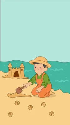 Boy in a straw hat building a sandcastle on the beach