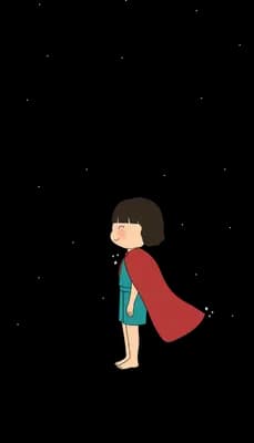 Girl in a red cape standing alone at the edge of a grey rock