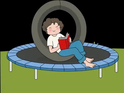 Boy lying on a blue trampoline reading a red book with a tyre swing above