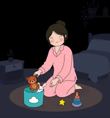 Woman in pink pyjamas kneeling on a rug tidying toys into a basket in a dark bedroom