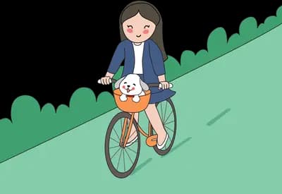 Woman cycling uphill with a dog in the basket