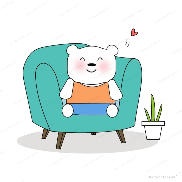 Bear working on a laptop on a teal sofa