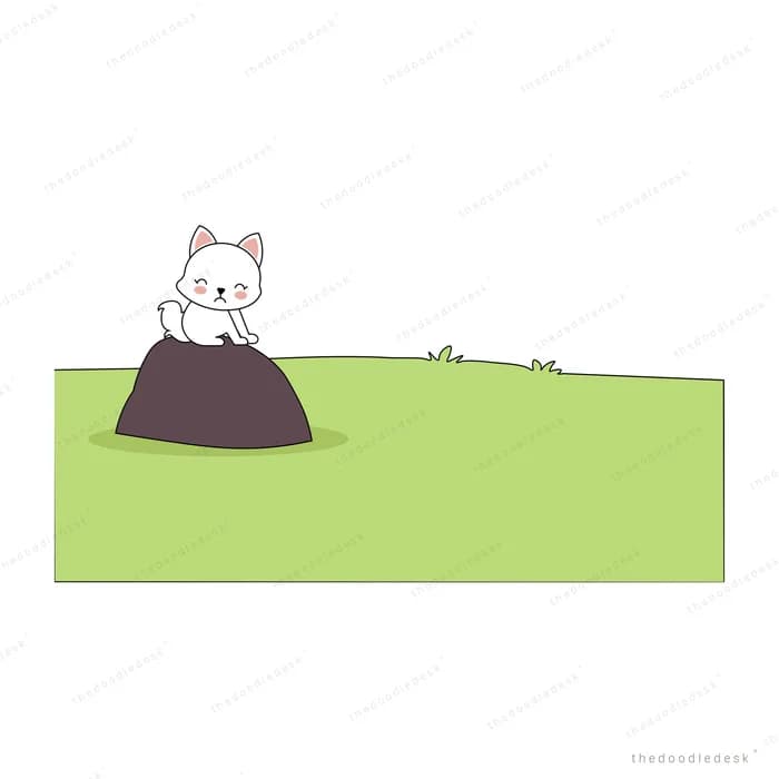 White kitten sitting on a dark mound of soil on a green hill