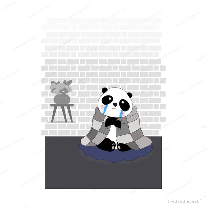 Panda in a blue scarf huddled under a checkered blanket on a rug against a brick wall