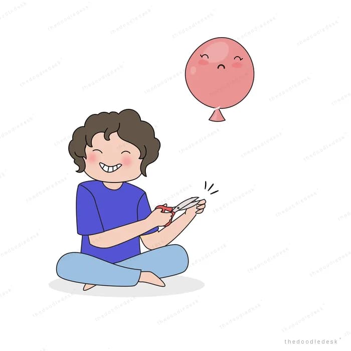 Boy sitting cross-legged clapping at a balloon