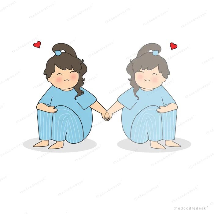 Two women in pyjamas sitting side by side holding hands