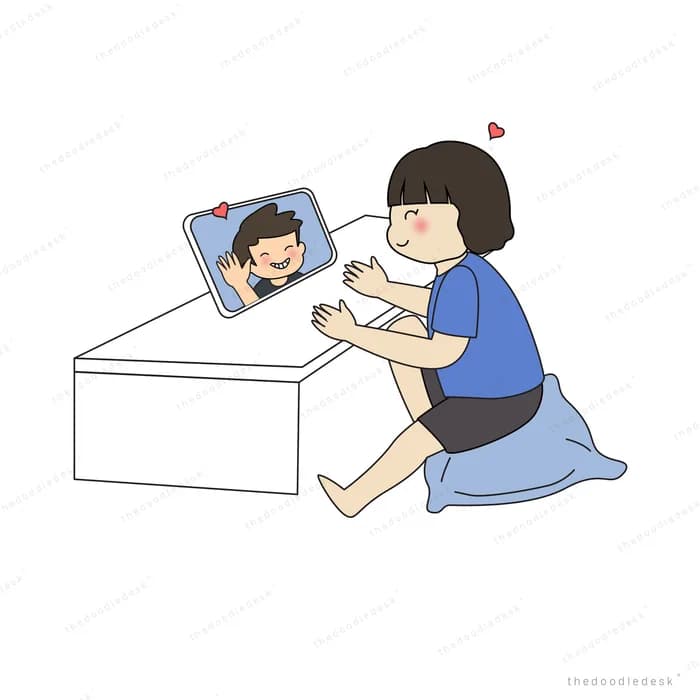 Woman kneeling to reach a phone screen showing a face
