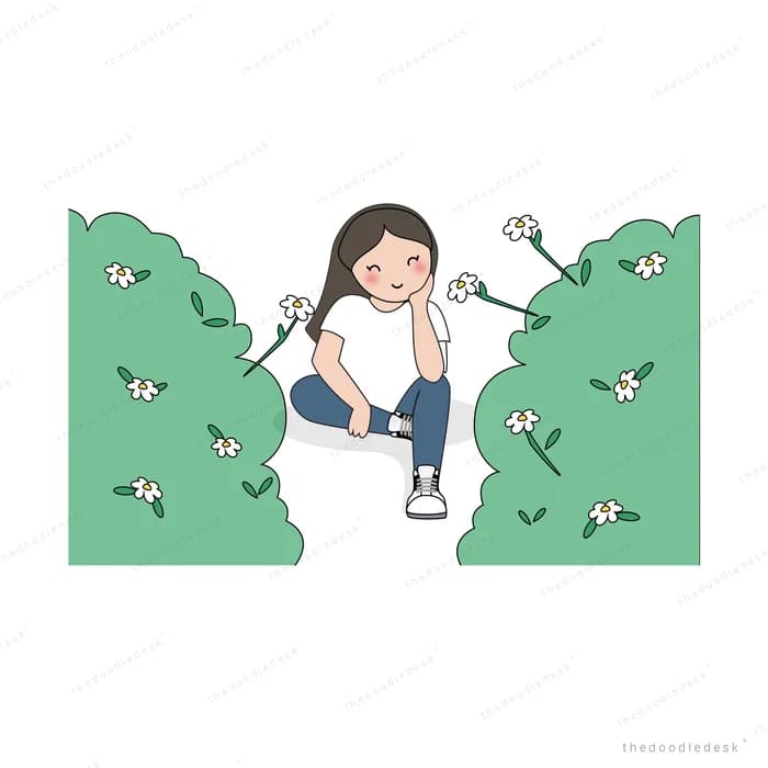 Woman sitting between green hedges of white flowers
