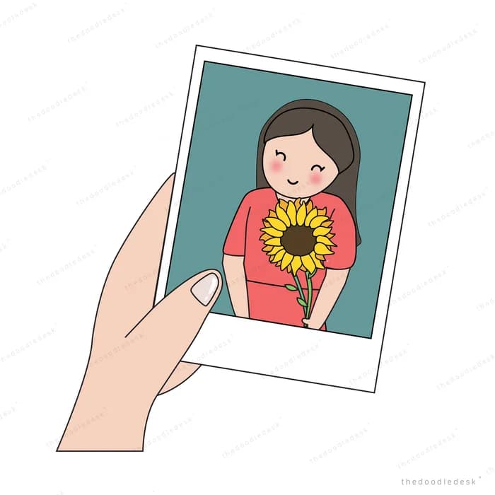 Hand holding a photograph of a woman with a sunflower