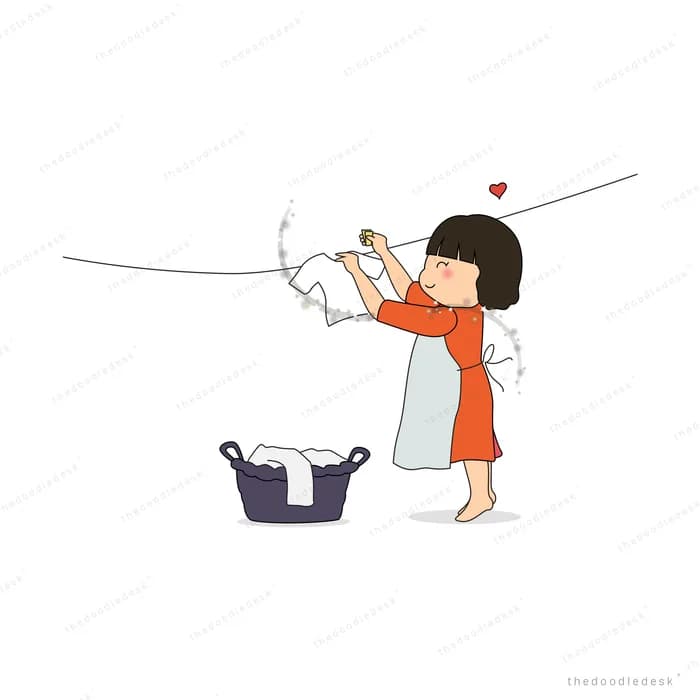 Girl hanging laundry on a line with a bag below
