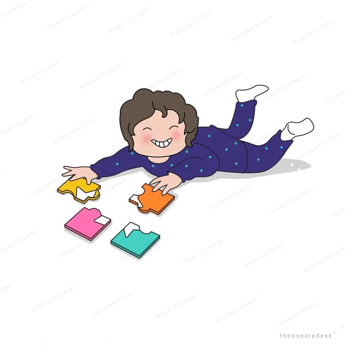 Girl lying on her front reading with books scattered