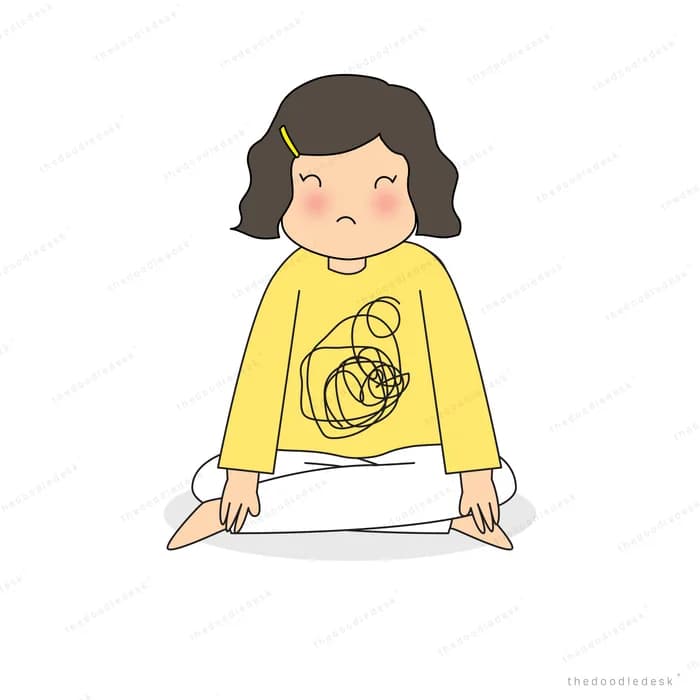 Woman sitting cross-legged looking downcast