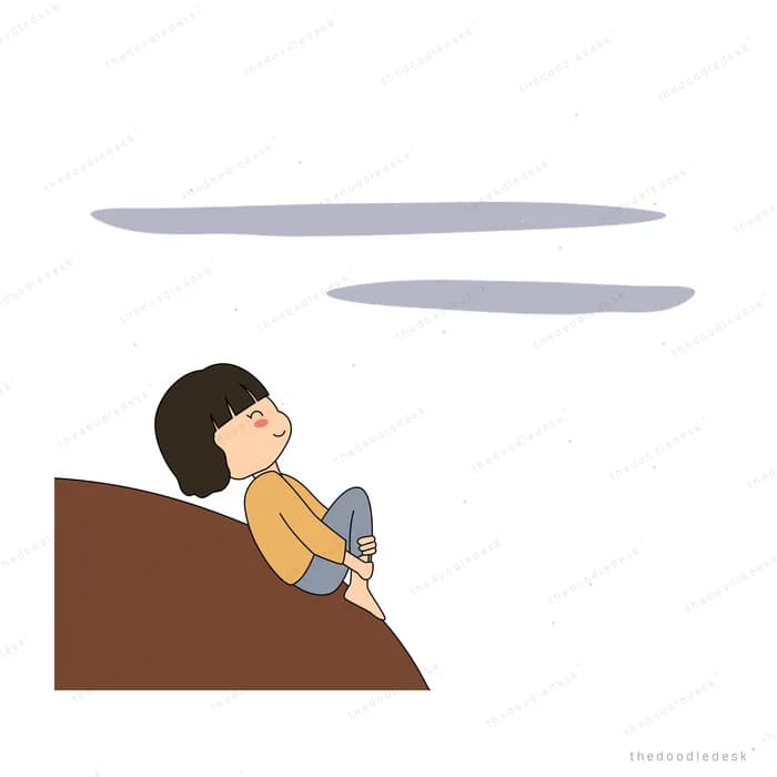 Girl sitting hugging her knees on a brown hillside watching clouds drift
