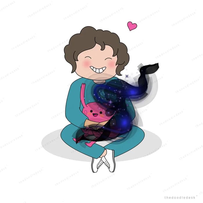 Boy sitting on the floor hugging a large dark blue balloon and a pink toy