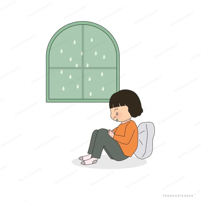 Girl sitting hugging her knees on the floor below a closed window