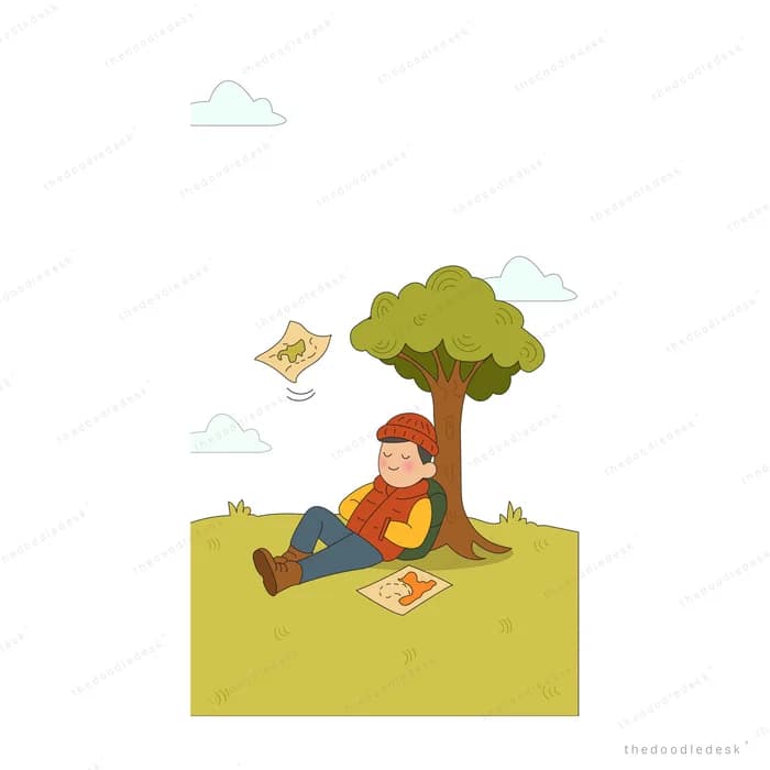 Boy sitting under a tree folding paper planes on a picnic mat