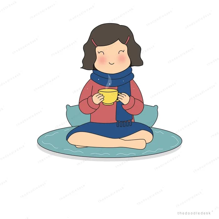 Girl sitting cross-legged on a cushion cradling a warm mug
